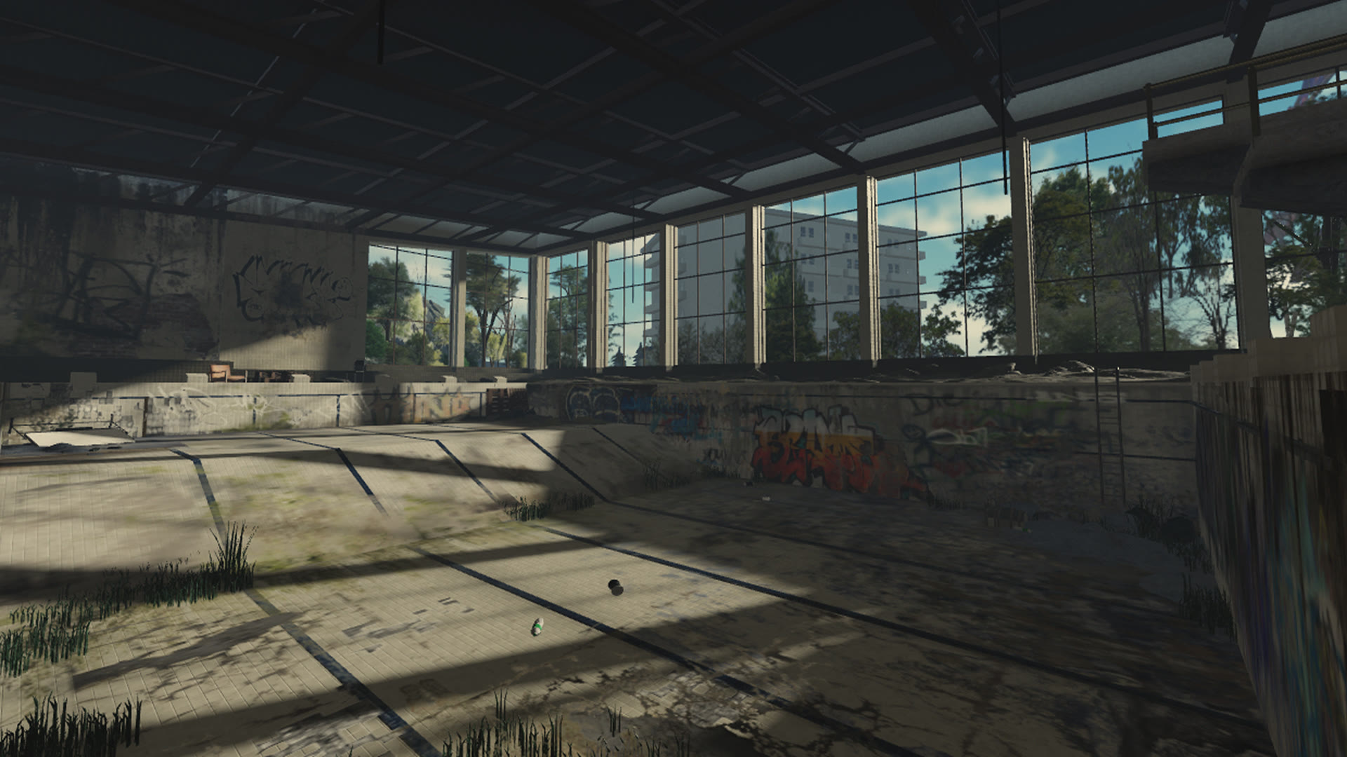 An abandoned indoor pool build seen through a wide architectural frame.